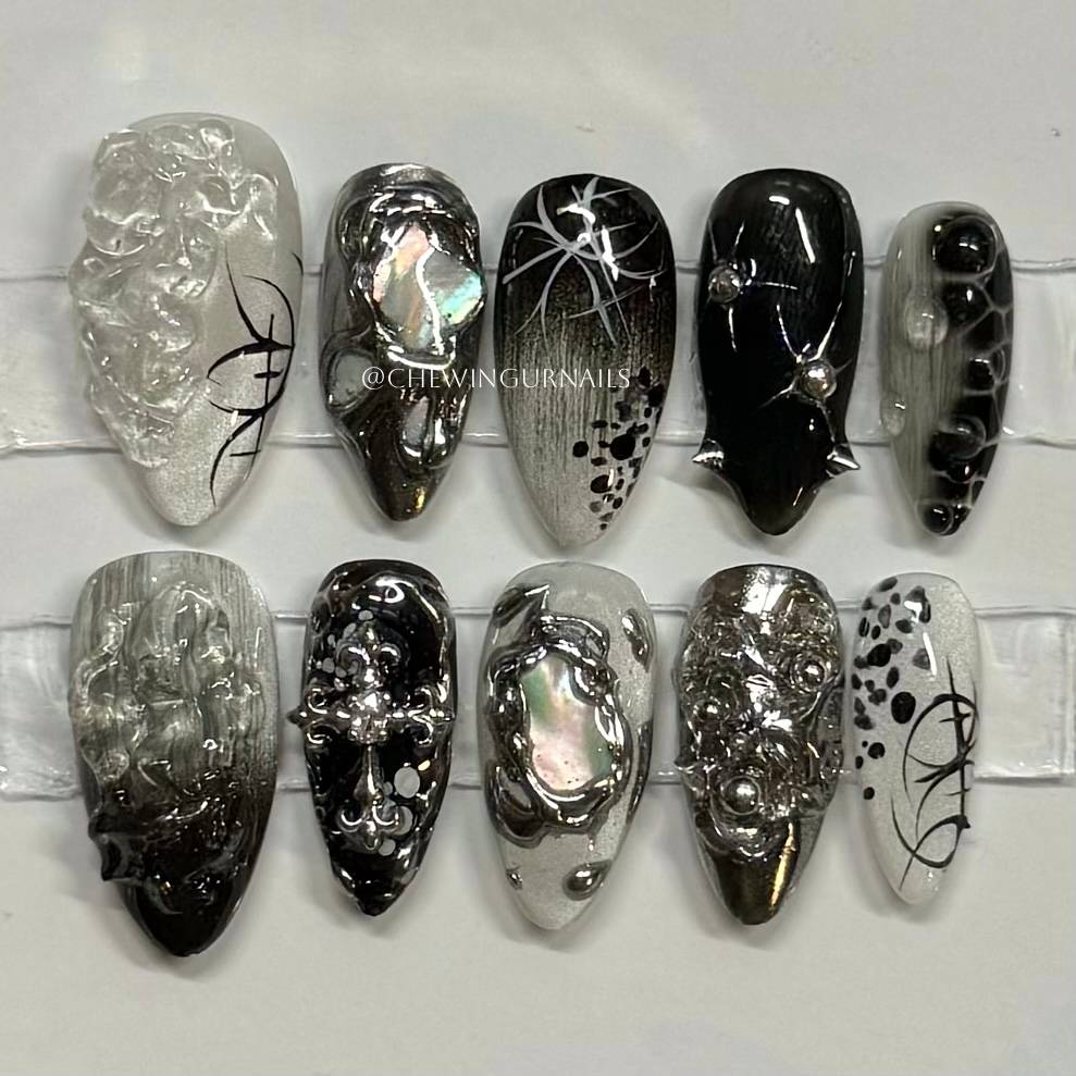 Collection of black, silver, and white nail art designs on a white background